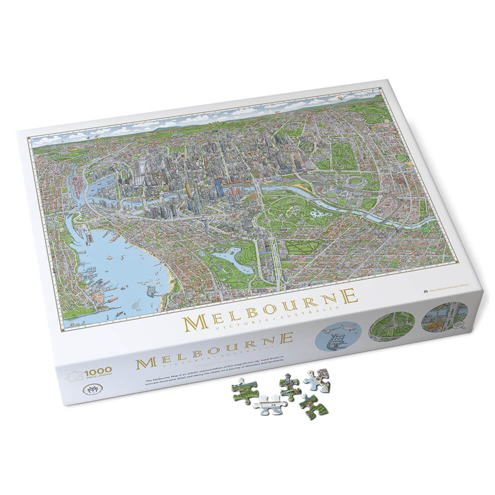 The Melbourne Map 1,000-piece jigsaw puzzle. The image shows the whole box on a slight angle and 4 loose pieces in the foreground