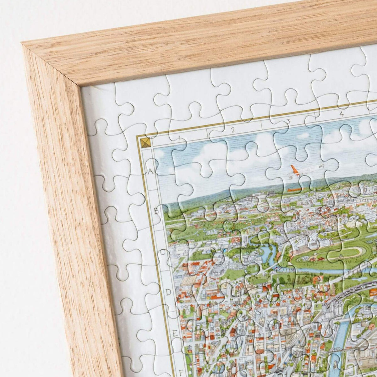 The Melbourne Map 1,000-piece jigsaw puzzle completed and framed in a Frames Now custom oak frame on a white background.  