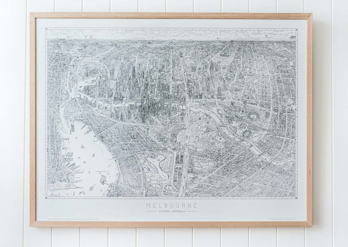 The Melbourne Map Black and white line drawing shown in a large version of the open edition. Framed in oak and hanging on a panelled wall in a bright, airy room. 