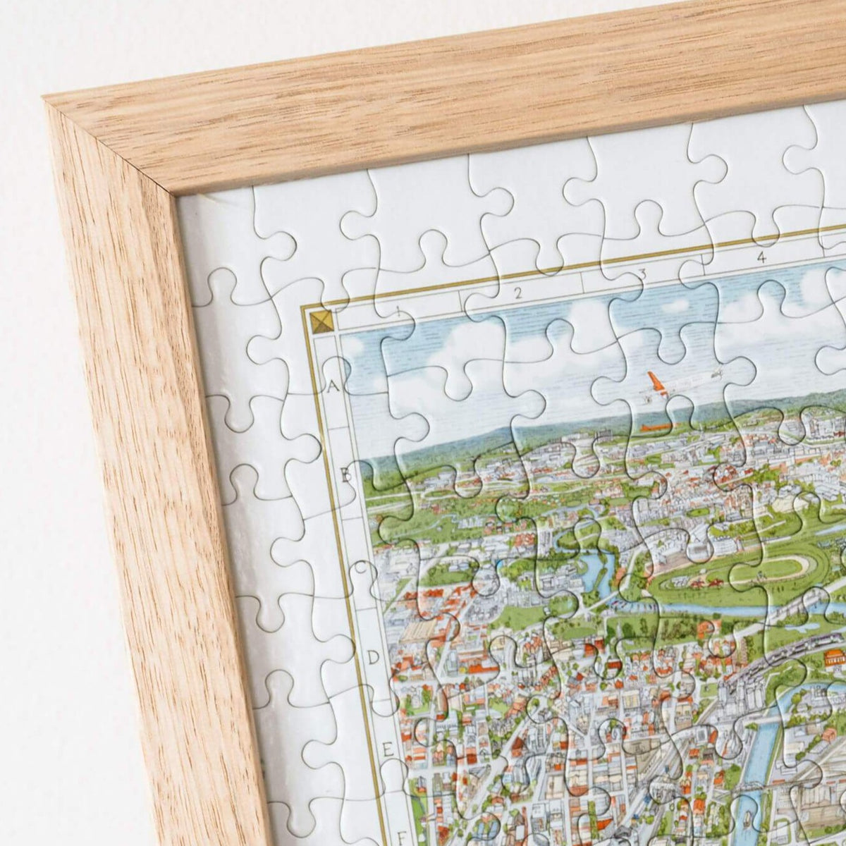 The Melbourne Map 1,000-piece jigsaw puzzle completed and framed in a Frames Now custom oak frame on a white background.