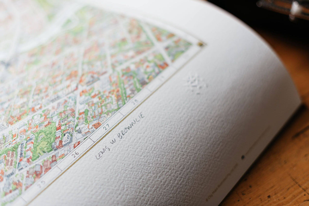 A close up of the embossing detail on The Melbourne Map limited edition. The image shows the signature of artists Lewis Brownlie and the quality of the archival paper used as well as the detail on the drawing 